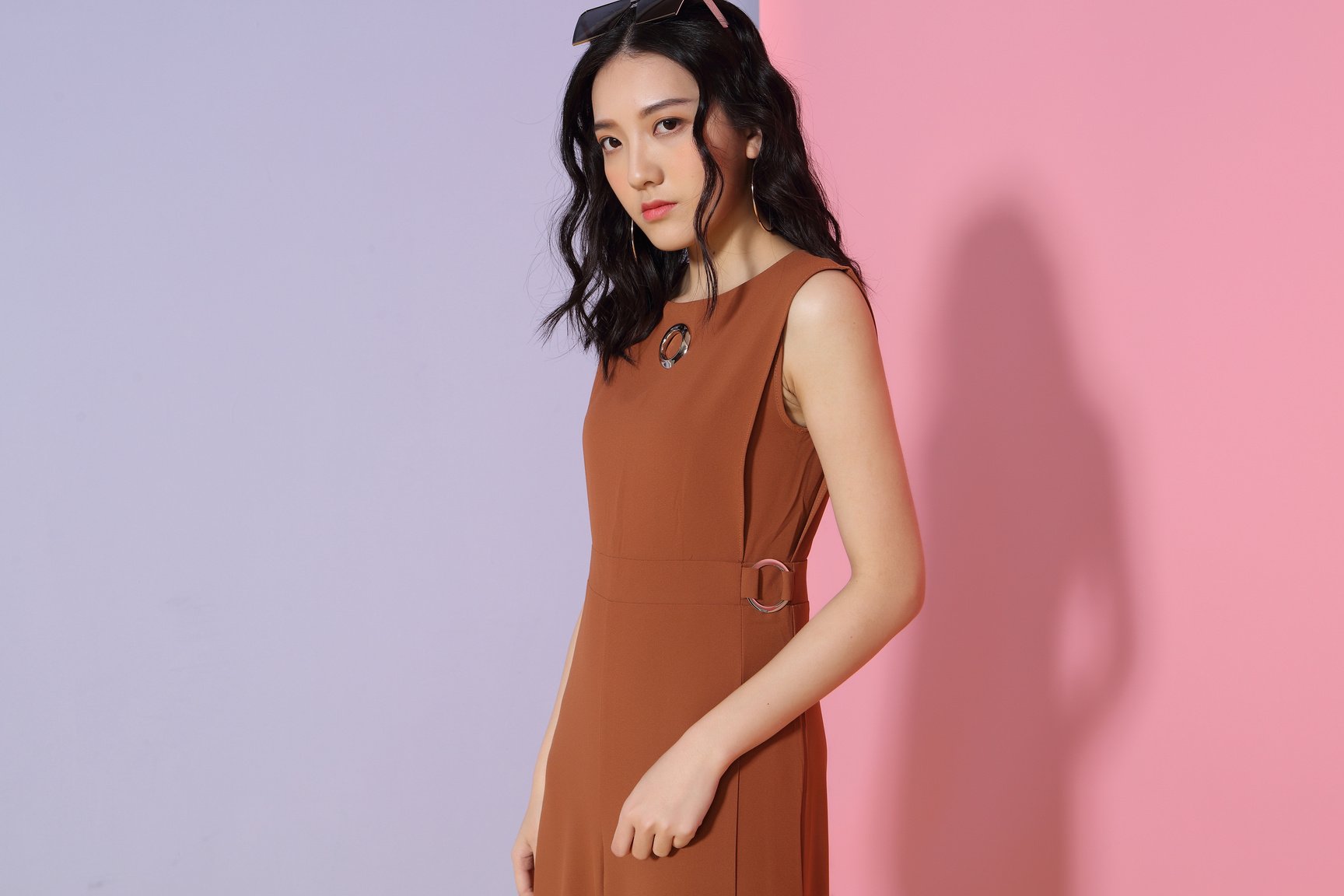 Woman in fashionable brown outfit in studio