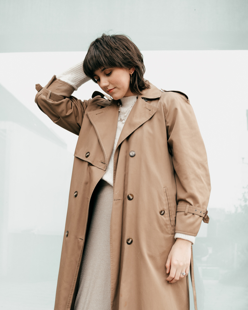 Fashionable young woman touching hair on street